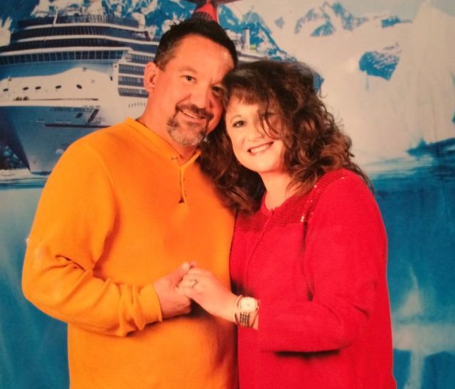 Smiling couple, hand in hand pose on cruise ship