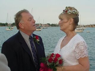 Senior Christian couple marry overlooking the ocean