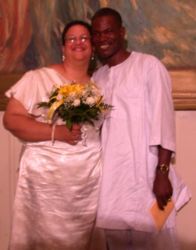 Interracial couple smile broadly on their wedding day