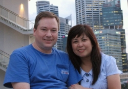 An American Christian single sits next to an Asian Christian woman in Singapore