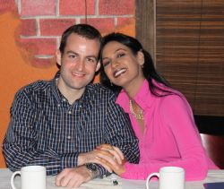 Beautiful Louisiana Christian couple site lovingly together in a cafe and smile