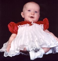 Cute baby girl in white and red dress