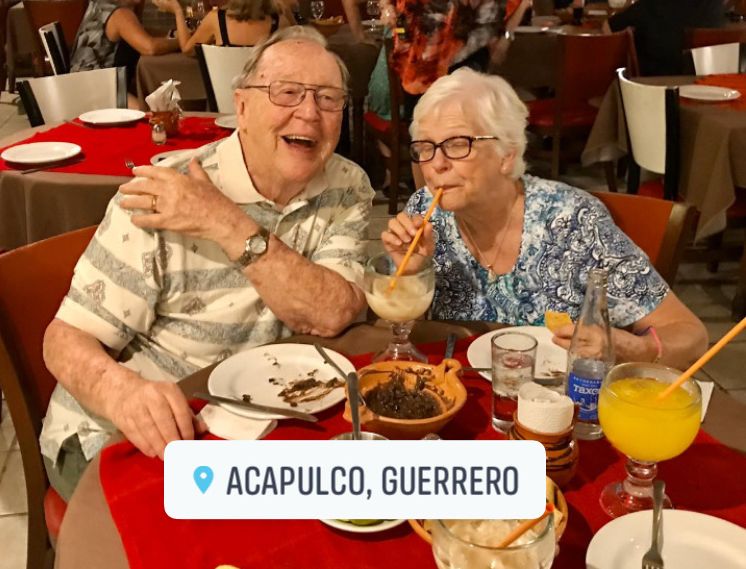 Senior Christian couple fully at ease together in restaurant while on honeymoon in Acapulco