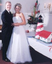 Michigan Christians hug happily next to their wedding cake