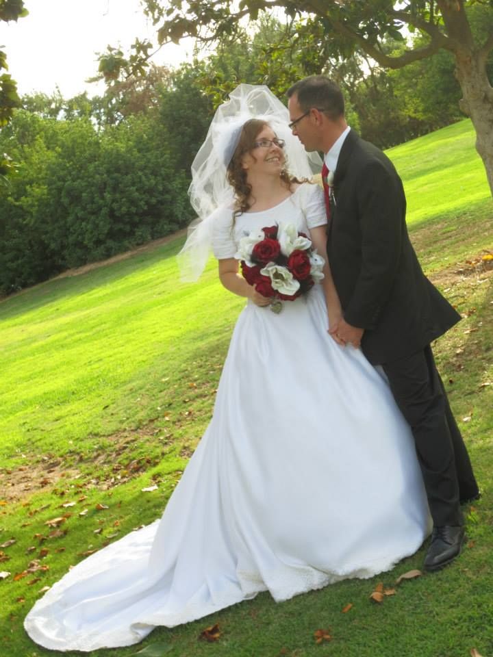 Former Christian singles now married gaze lovingly on the grass in sunshine