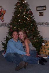 California Christian singles cuddle by a Christmas tree