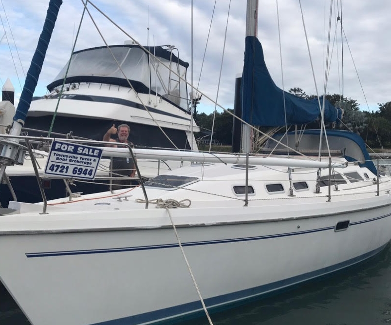A man gives the thumbs up sign as he stands behind his new boat