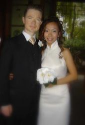 Australian Christian single stands next to his beautiful bride from Singapore