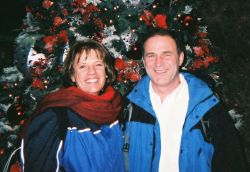 American Christian singles smile after meeting in front of a Christmas tree