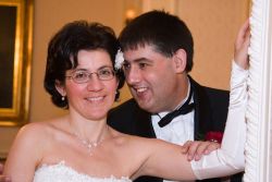English Christian couple marry. Husband whispers in his wife's ear as she smiles
