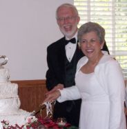 Laughter from the newlyweds as they cut the wedding cake