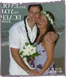 Hawaiian wedding for a happy Christian couple who hug on the beach