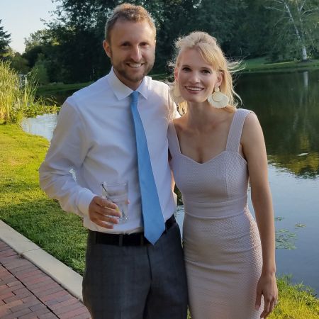 Christian couple all dressed up and standing in front of water