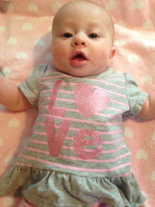 Super cute baby girl wearing a love shirt