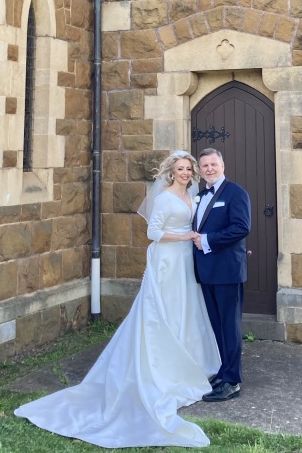 A beautiful bride with her new husband in front of a church in Melboune, Victoria, Australia