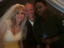 A beautiful White woman poses next to wedding guests