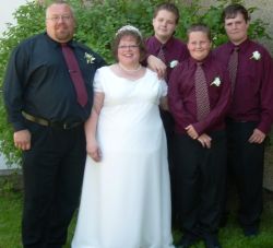 Divorced man poses with his sons and his new bride, smiles all around