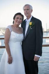 Older single Christians pose next to the water after marrying