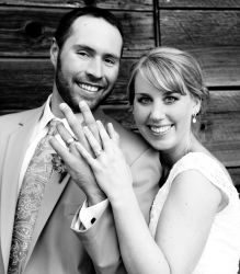 An ecstatic newly engaged Christian single shows off her wedding ring next to her husband