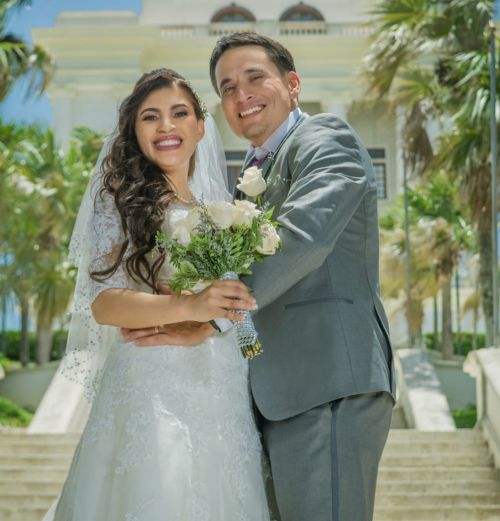 US Christian single poses after marrying Dominican wife who is holding bouquet