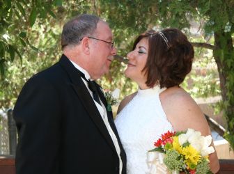 A former single Christian from California smiles with eyes closed as her new husband leans in to kiss her