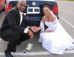 Christian single finds romance with Hawaiian and they hold hands while posing behind their wedding car