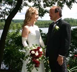 Newly married Christians from Quebec stare at each other lovingly near a river