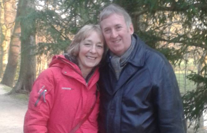 Mature Christian couple in love while on a cold forest walk