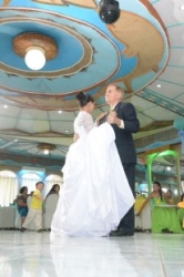 Newly married Interracial couple dance in a ballroom