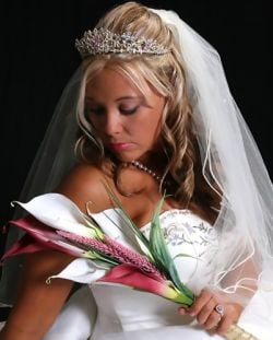 Beautiful Christian bride looks down at her flowers