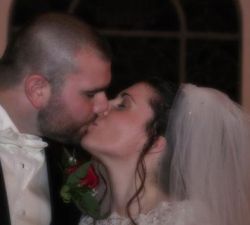 Christian bride and groom lovingly kiss