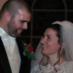 A bride laughs as she looks up at her new husband who only has eyes for her