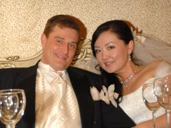 American marries a Christian woman from Kazakhstan who looks radiant at their reception table