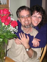 A single Christian woman hugs a happy man from behind