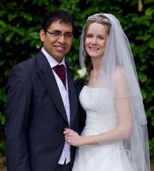 American Christian single smiles as he marries a beautiful woman from England outdoors