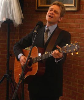Christian performer sings and plays at a Christian wedding
