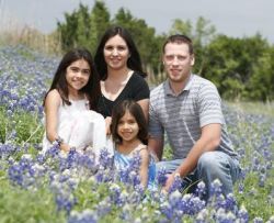 Gorgeous flowers and children surround Christian parents in spring