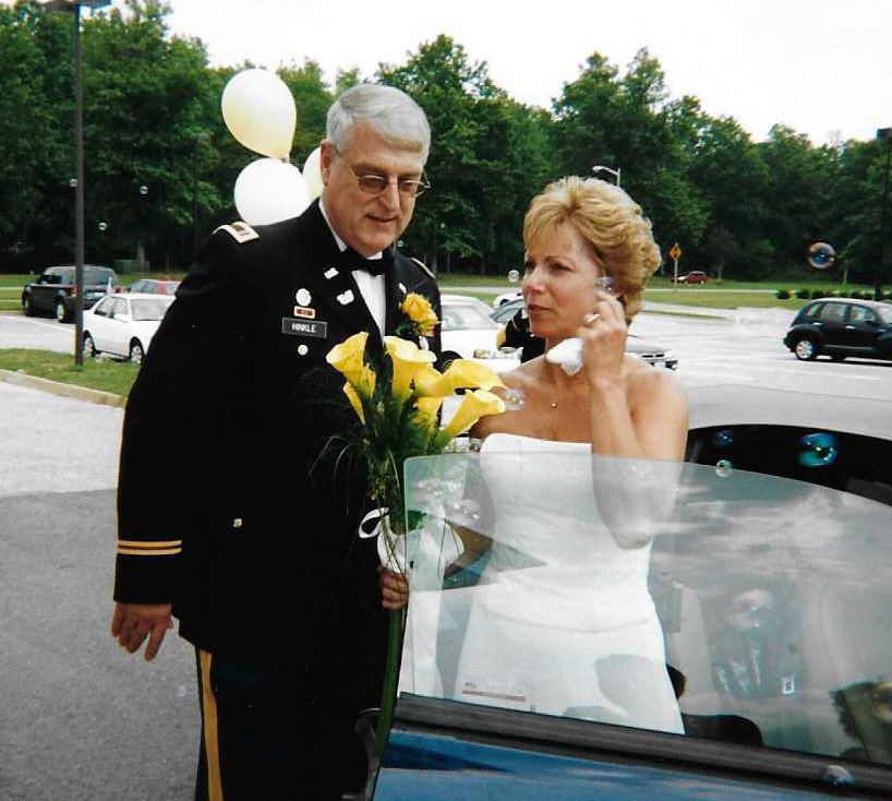 A Christian man in military uniform stands next to his new bride