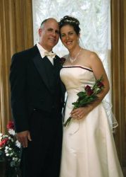 Perfectly matched Christian singles from Ontario laugh and stand cheek to cheek after marrying