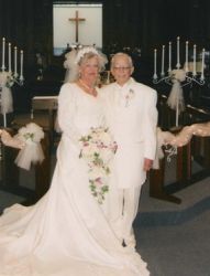 Newly married senior Christians stand side by side at the altar
