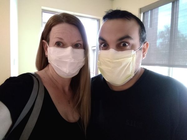 Christian couple being silly while wearing COVID masks