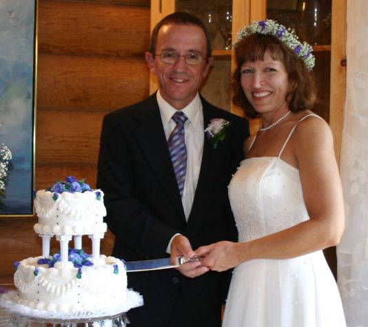 Very happy formerly single Christian from Arkansas cuts wedding cake with California Christian match