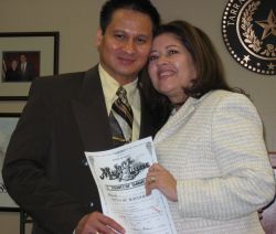 A married couple hold up their marriage license