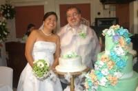 Newlyweds burst out laughing while trying to pose in front of their Wedding cake