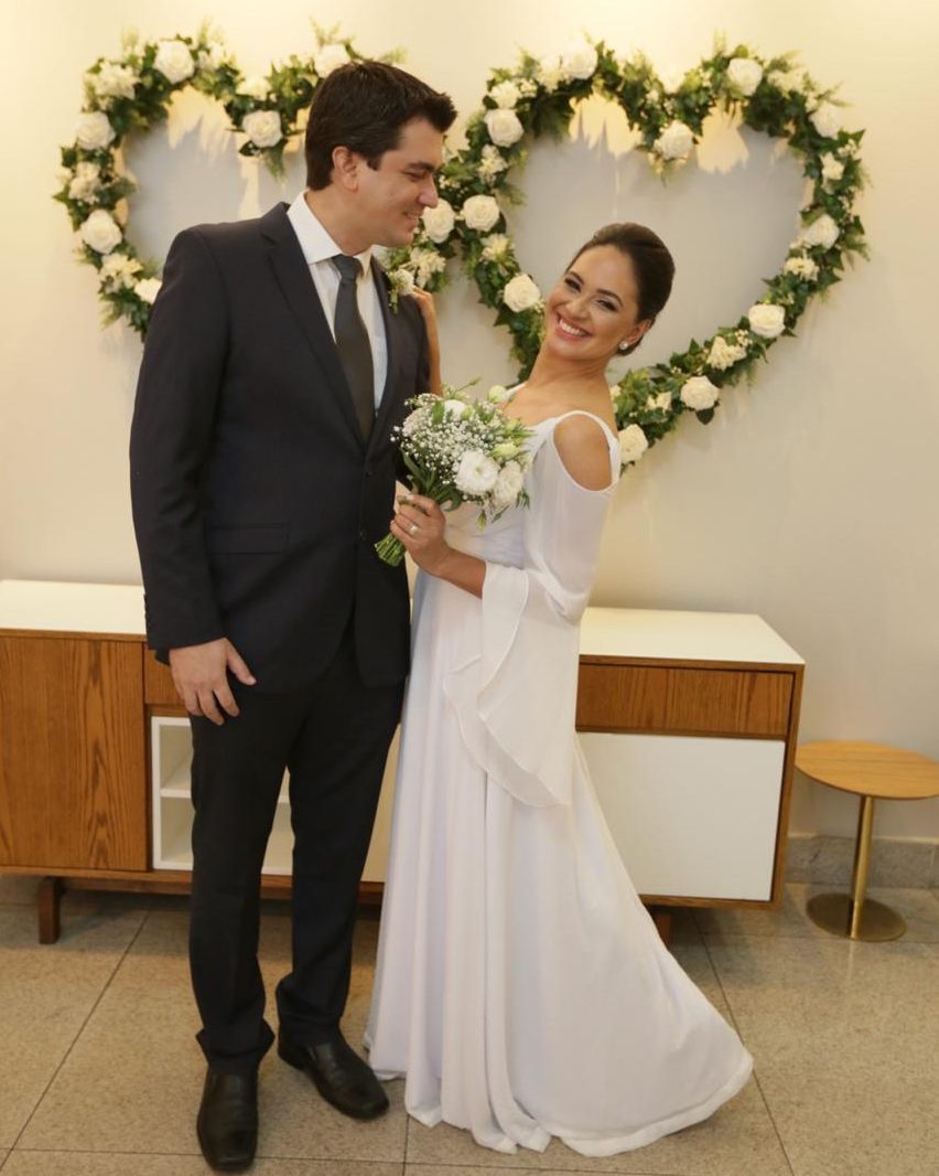 Christian groom smiling at his Brazilian Christian wife while she beams at camera