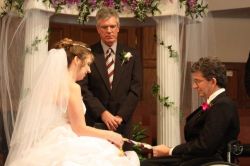 TN Christian single in a wedding dress sits next to an Alabama Christian single at their wedding