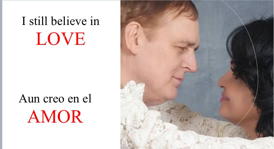 A newly married Christian couple gaze into each other's eyes next to a written statement of love in English and in Spanish