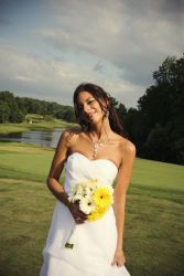 A beautiful Christian woman poses outdoors in her wedding dress