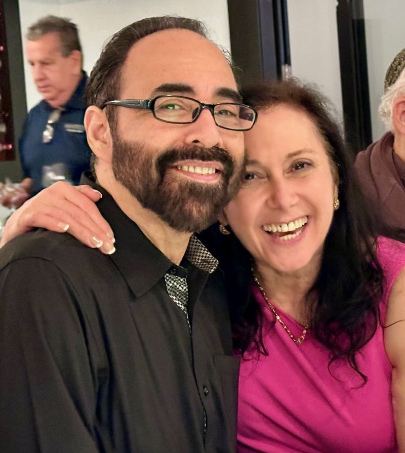 Messianic Jewish believers laugh while cuddling together at a celebration