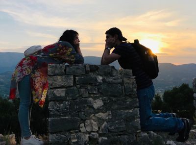 Sunset photo for Christian couple on mountain top while facing each other